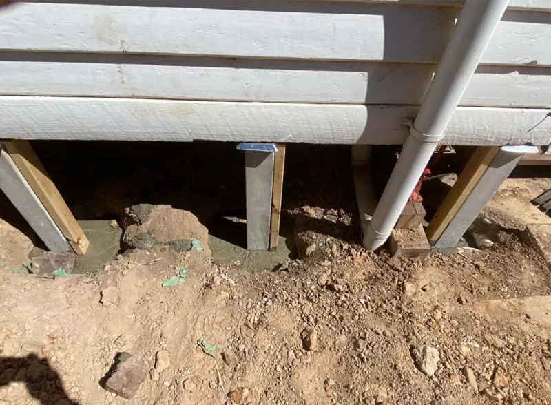 New stump and bracket fitted beneath a weatherboard home – underpinning and reblocking in Barwon Heads