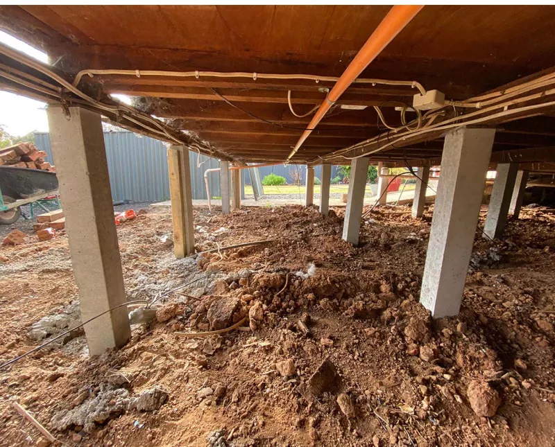 Row of new concrete stumps under a house during reblocking – underpinning and reblocking in Ocean Grove