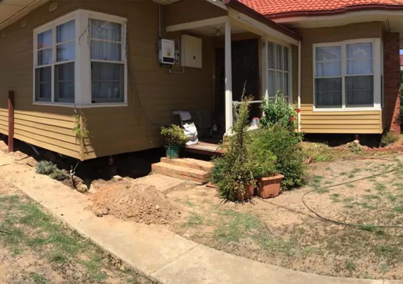 Common Structural Issues Queenscliff Homeowners Experience Weatherboard home with excavation along the front for foundation repairs – underpinning and reblocking in Queenscliff