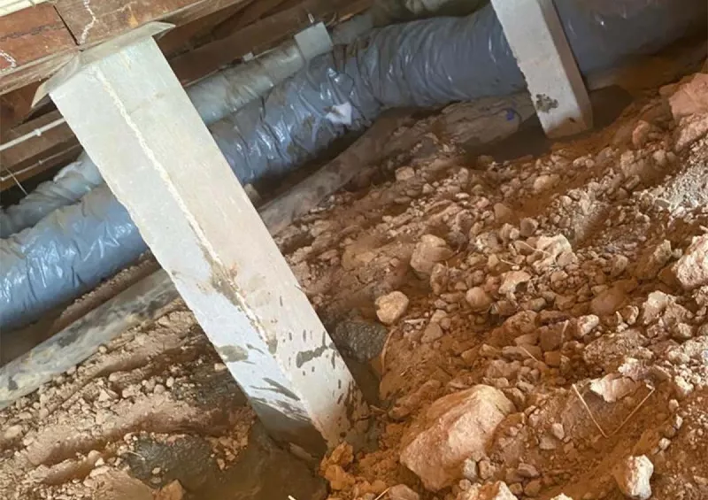 New concrete stump set into rocky ground under a subfloor – underpinning and reblocking in Anglesea